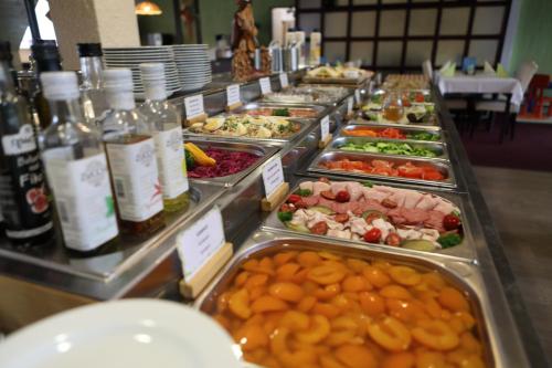 a buffet line with many different types of food at Hotel Skicentrum in Harrachov