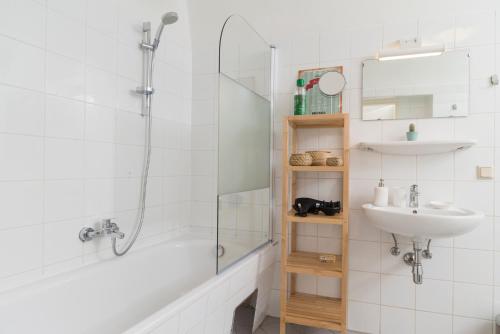 a bathroom with a shower and a sink at Cozy Kunsthaus GRAZ in Graz
