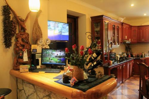 a kitchen with a desk with a computer on it at Sapa Garden Bed and Breakfast in Sa Pa