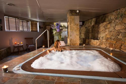a woman is sitting in a bath tub at Hotel Alba Seleqtta in Lloret de Mar