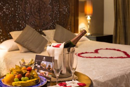 a bottle of champagne on a table in a hotel room at Hotel Alba Seleqtta in Lloret de Mar