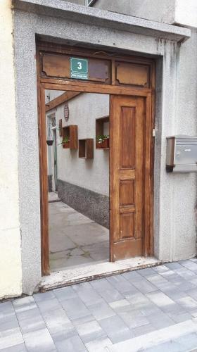 a wooden door on the side of a building at Apartment New Days in Sarajevo