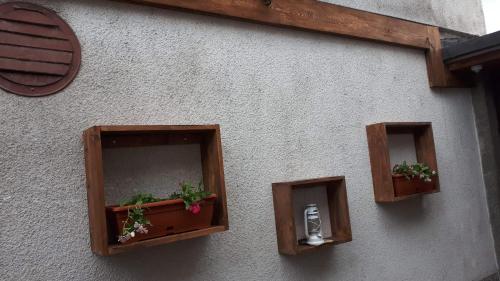 a building with three boxes with plants in them at Apartment New Days in Sarajevo
