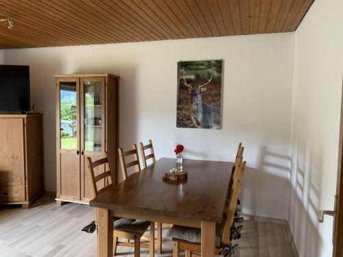 a dining room with a table and a deer on the wall at Schlossblickwohnung Schiel in Gernsbach