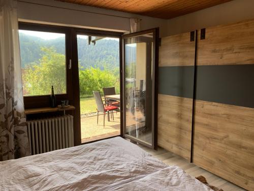 a bedroom with a bed and a view of a table at Schlossblickwohnung Schiel in Gernsbach