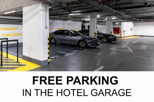a parking lot with cars parked in the hotel garage at Hotel Vision Budapest by Continental Group in Budapest