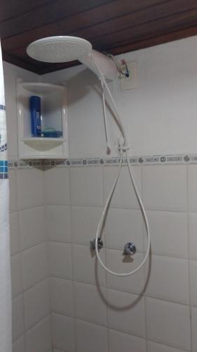 a shower head hanging from the wall of a bathroom at Sítio Canto das Águas in Marechal Floriano