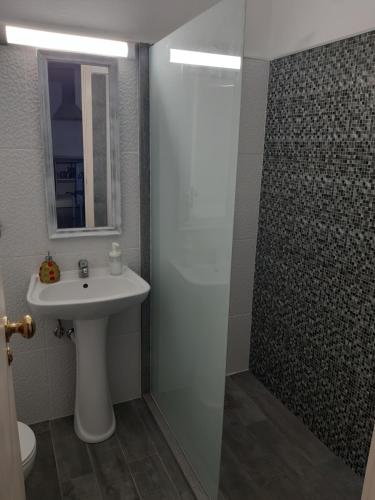 a bathroom with a sink and a shower at Apartamentos América - Blue Sea in Funchal