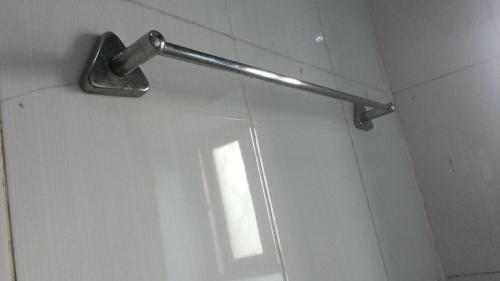 a metal pole on the wall of a bathroom at Leosim Hotel Nebbi in Nebbi