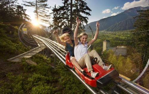 two people are riding on a roller coaster at Haus Annemarie Apartments Kartitsch - Hochpustertal in Kartitsch