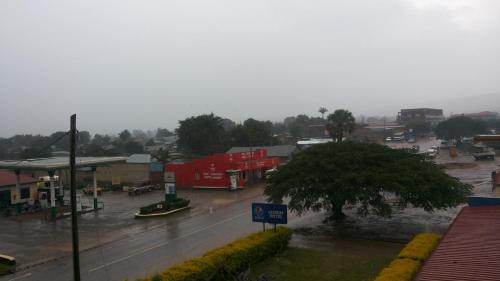 a town with a gas station in the rain at Leosim Hotel Nebbi in Nebbi