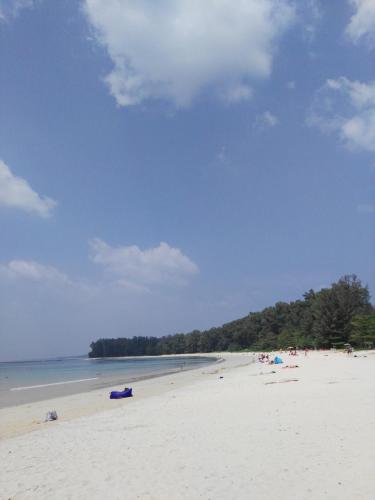 a beach with a bunch of people on it at Luxury Apartment at Title Residencies Naiyang Beach in Phuket Town
