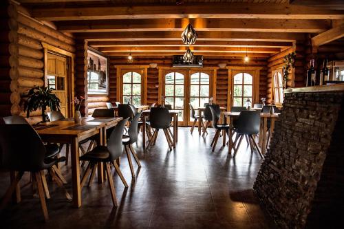 a dining room with wooden walls and tables and chairs at Grand Slam Park Inn in Budapest