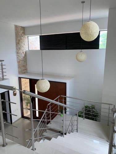 a staircase in a house with two pendant lights at Casa Campestre en Condominio Lagos Del Peñon in Girardot
