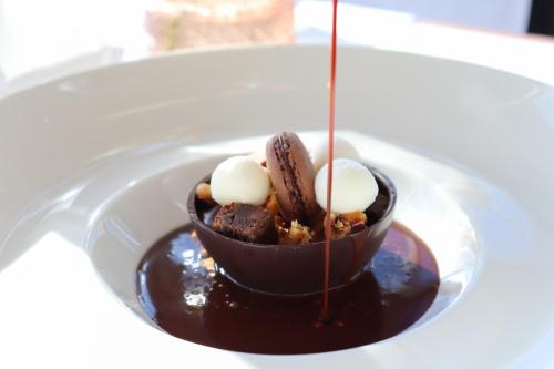 a chocolate dessert on a plate on a table at Carden Park Hotel, Golf Resort and Spa in Tilston
