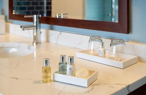 a bathroom sink with two bottles on a counter at Harbor View Hotel in Edgartown