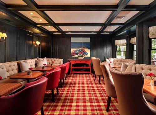 a restaurant with tables and chairs and a pool table at Harbor View Hotel in Edgartown