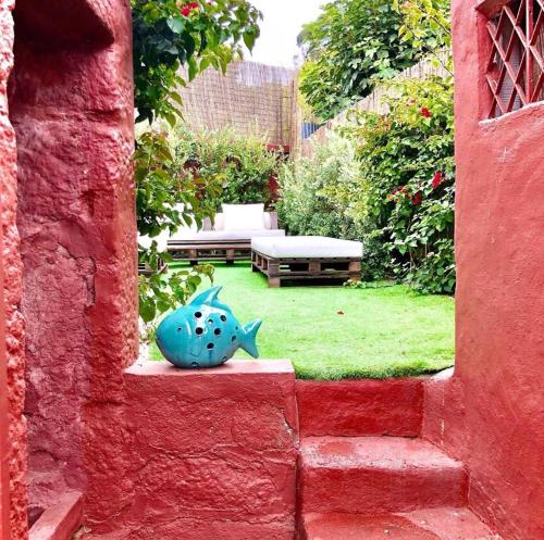 a garden with a blue fish statue in a yard at Arrábida House in Porto