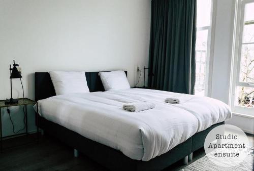 a bed with two towels on it in a bedroom at Rembrandt Square Hotel in Amsterdam