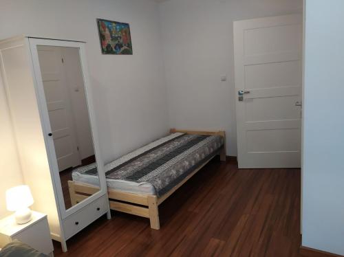 a bedroom with a bunk bed and a mirror at Park in Rymanów