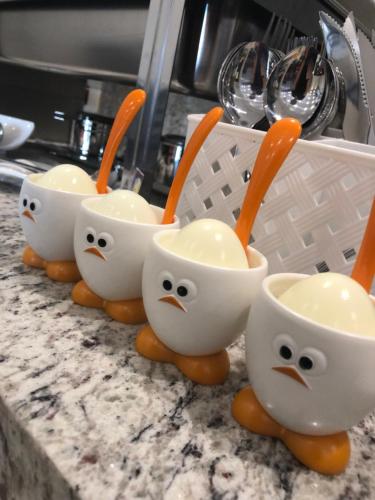 a group of bowls with spoons in them on a counter at Jandira Premiêr Hotel in Jandira