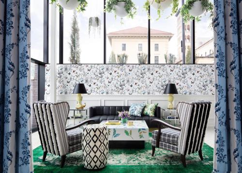 a living room with a couch and two chairs and a table at Graduate by Hilton Nashville in Nashville