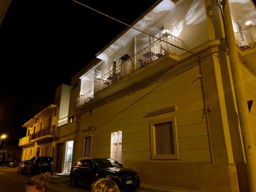 a building with a car parked on a street at night at Le Stanze Di Brando E Nico in Tricase