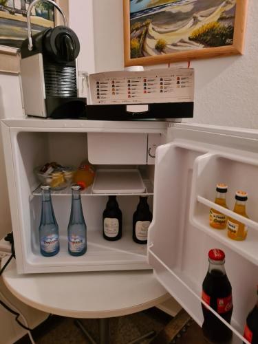 a refrigerator filled with lots of bottles of soda at Hübinger Treff in Hübingen