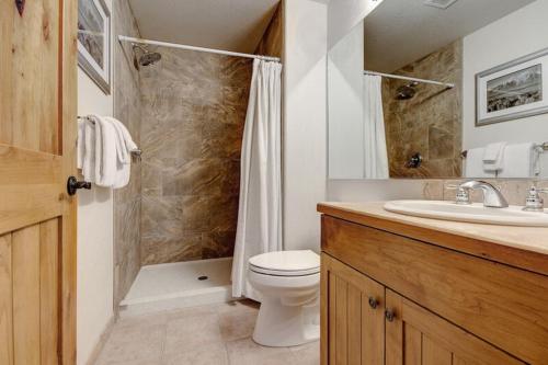 a bathroom with a toilet and a shower and a sink at Torian Plum Creekside II in Steamboat Springs