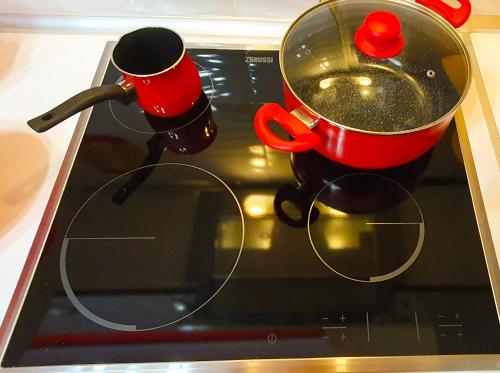 a pair of pots and pans on top of an oven at Apollo 2 - Luxury Apartment in Katerini