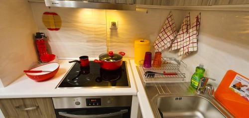 a small kitchen with a stove and a sink at Apollo 2 - Luxury Apartment in Katerini