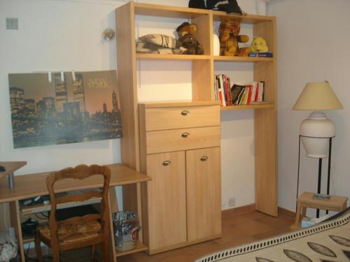 a room with a desk and a wooden book shelf at APPARTEMENT EN SOUS SOL DE VILLA avec accès jardin et piscine in Marseille
