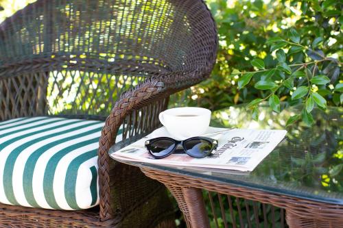 a wicker chair with a book and glasses on a table at 1842 Inn in Macon