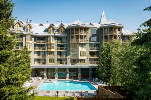 a large apartment building with a large swimming pool at Cascade Lodge in Whistler