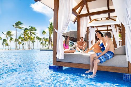 two women are lounging on a blue and white boat at Hyatt Ziva Cap Cana in Punta Cana