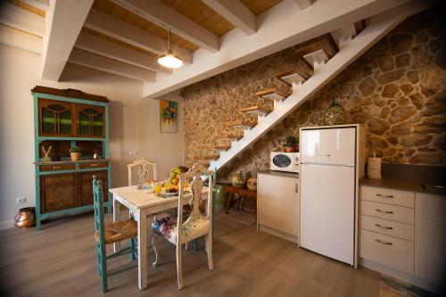 a kitchen with a table and a white refrigerator at Vistas de Chamberi in Alhama de Aragón