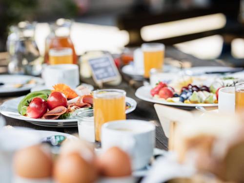 a table topped with plates of food and drinks at Urlaub am Bauernhof Feldbauer in Landl