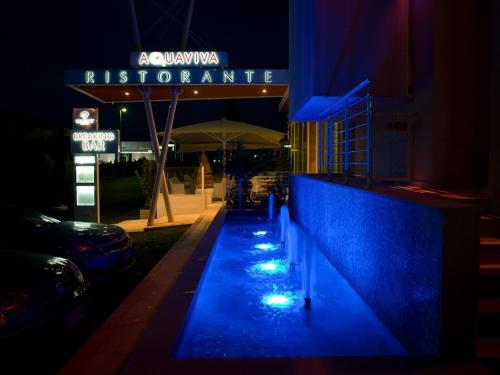 a night view of a restaurant with blue lights at Breaking Business Hotel in Mosciano SantʼAngelo