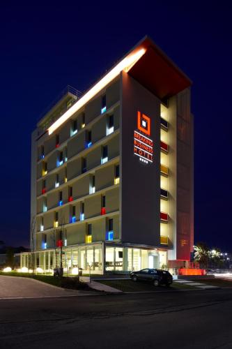 a building with a car parked in front of it at Breaking Business Hotel in Mosciano SantʼAngelo