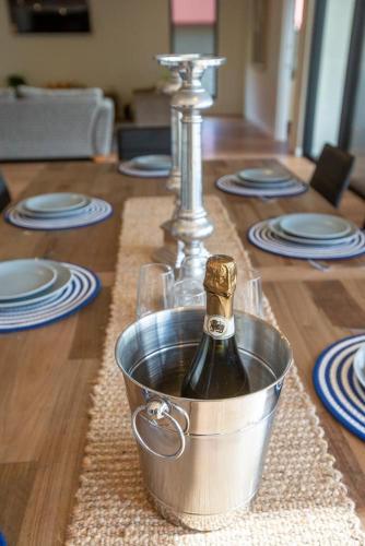 a bottle of wine in a bucket on a table at Johnnies in Robe