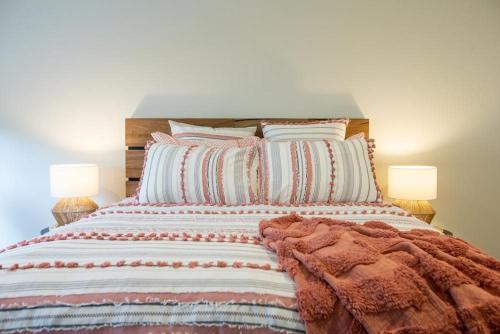 a large bed with pillows and a blanket on it at Johnnies in Robe