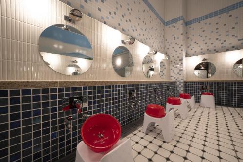 a bathroom with a row of red and white toilets at Umekoji Potel KYOTO in Kyoto