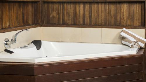 
a bath tub sitting next to a bath tub sink at Oaks Port Douglas Resort in Port Douglas
