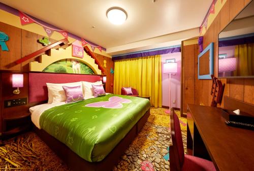 a room with a bed, a chair, and a painting on the wall at LEGOLAND Japan Hotel in Nagoya