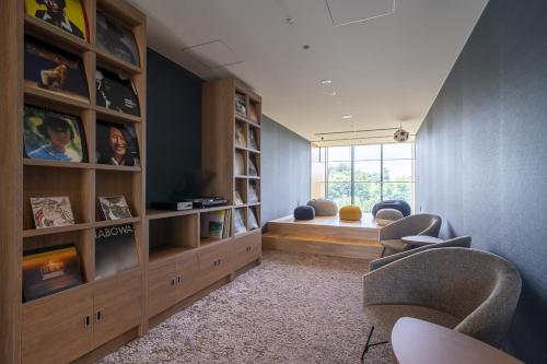 a living room with two chairs and a television at Umekoji Potel KYOTO in Kyoto