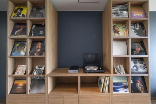 a book shelf filled with lots of books at Umekoji Potel KYOTO in Kyoto