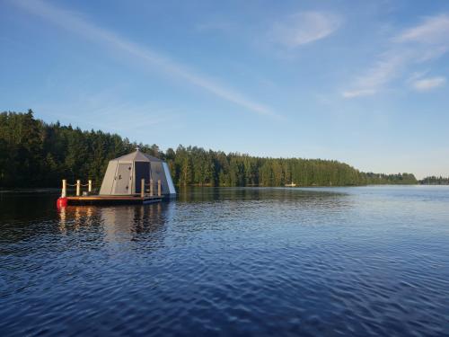 a small boat in the middle of a lake at Koivuranta Igloos in Oulu