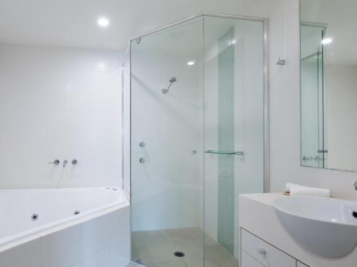 a bathroom with a glass shower and a sink at Pacific Blue 245-265 Sandy Point Rd - Dual Key Access, air conditioned unit with resort facilities and linen supplied in Salamander Bay