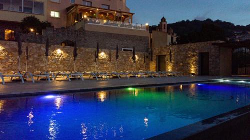 a large swimming pool in a large building at Hotel La Santa in Santa-Reparata-di-Balagna