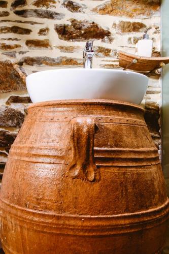 a bathroom sink sitting on top of a wooden barrel at Traditional Apartments Elafos in Elafonisi